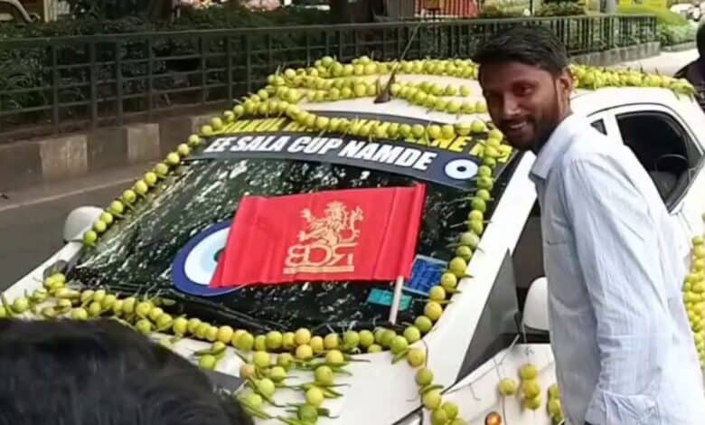 RCB fan poses next to car deocrated with Nimbu mirchi ahead of ipl final