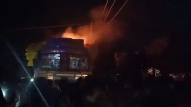 The image displays a picture of a Hindutva mob setting a truck in fire in UP