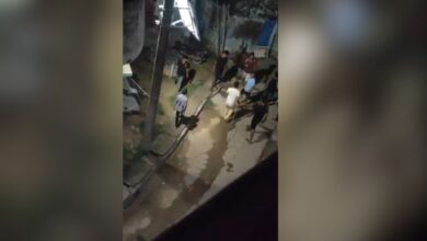 The image displays a picture of young men with sticks in Bihar