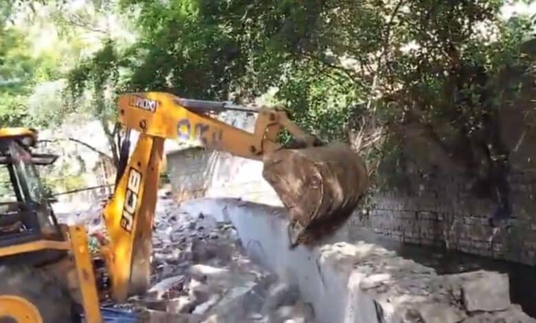 A bulldozer demolishing encroachments in Patny