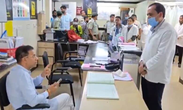 The image displays Goa health minister Vishwajit Rane (seated) losing his cool on chief medical officer Dr Rudresh Kurtikar