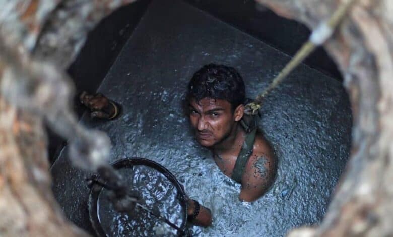 the image displays a picture of manual scavenger worker