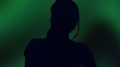 The image displays a picture of a woman with green background