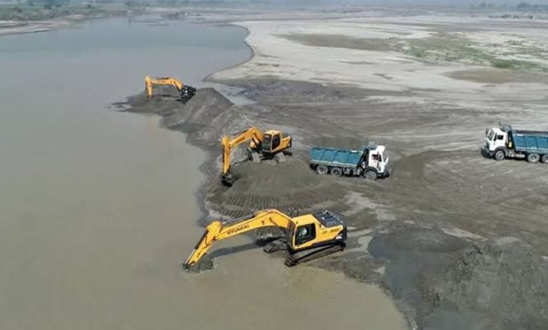 The image displays a picture of illegal sand mining in Chhattisgarh