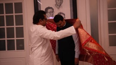 The image displays a file picture of Devendra Fadnavis and Raj Thackeray