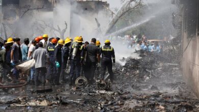 The image of Firefighters attempt to extinguish flames at the crash site of an Air India Boeing 787 Dreamliner in Ahmedabad, India, on 12 June, surrounded by debris and thick smoke.