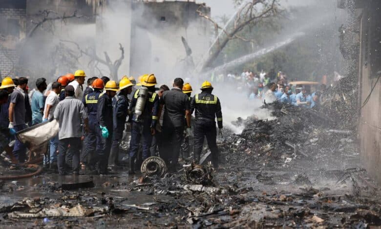 The image of Firefighters attempt to extinguish flames at the crash site of an Air India Boeing 787 Dreamliner in Ahmedabad, India, on 12 June, surrounded by debris and thick smoke.