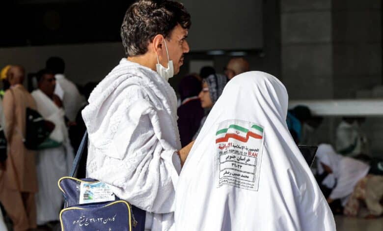 The image of a Iranian Haj pilgrims ihram attire at a gathering point, with identification tags visible on their clothing during Haj 2025 in Saudi Arabia.