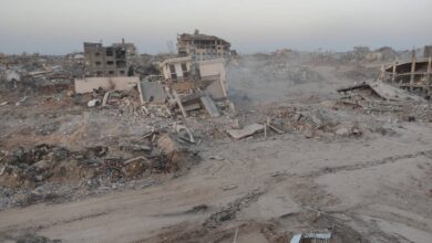 Widespread destruction in the northern Gaza Strip showing the rubble and ruins of the Noura Al-Kaabi Dialysis Centre after it was completely demolished by Israeli forces. Collapsed buildings and debris cover the area.