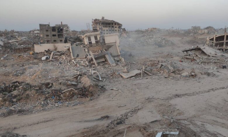 Widespread destruction in the northern Gaza Strip showing the rubble and ruins of the Noura Al-Kaabi Dialysis Centre after it was completely demolished by Israeli forces. Collapsed buildings and debris cover the area.