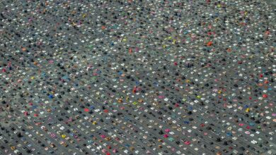 Aerial view of thousands of children's shoes arranged in neat rows across Stadhuisplein (City Hall Square) in Almere, Netherlands, as part of a memorial installation for Palestinian children killed in Gaza.