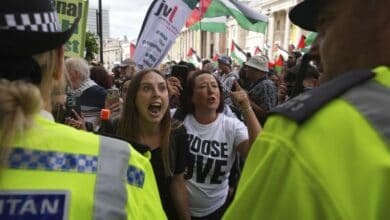 1 of 5 | Demonstrators shout and gesture toward a police line during a protest by Palestine Action group in London, Monday, June 23, 2025. (AP Photo/Frank Augstein)