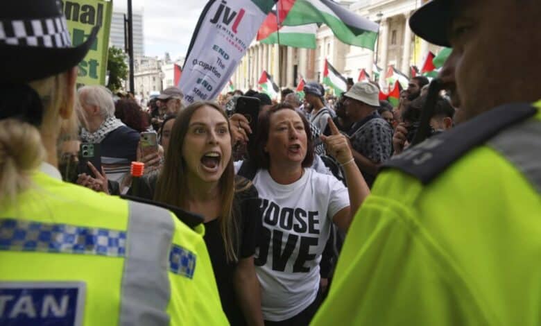 1 of 5 | Demonstrators shout and gesture toward a police line during a protest by Palestine Action group in London, Monday, June 23, 2025. (AP Photo/Frank Augstein)
