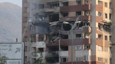 A damaged building in Tehran with shattered windows and debris on the ground following Israel’s strikes on Iran.