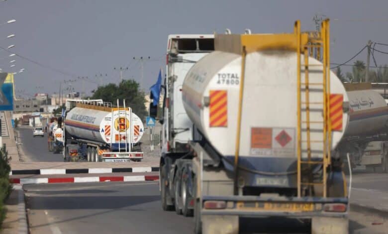 A convoy of fuel tankers drives through a street in Gaza, delivering much-needed fuel amid ongoing shortages. This marks the first UN-permitted fuel delivery into the territory in over 130 days, as humanitarian conditions remain dire.