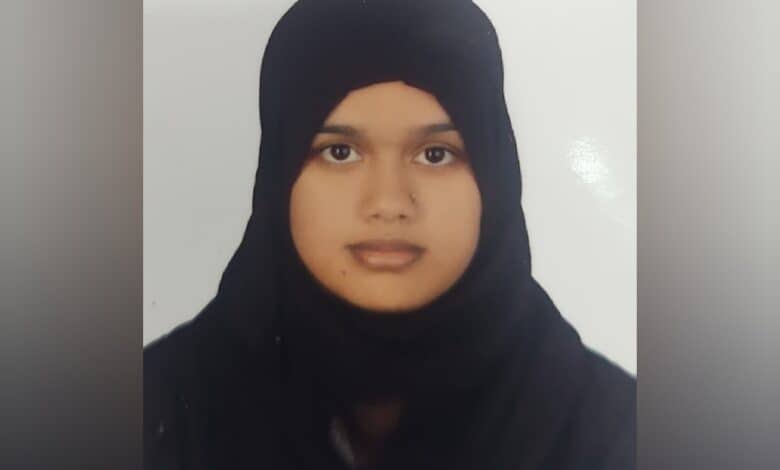 Ameena Begum wearing a black hijab, facing the camera in a passport-style photo.