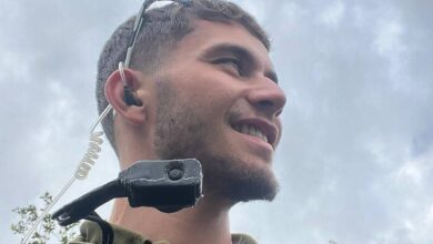 The image of a Reei Biran, 21-year-old IDF squad commander in the Golani Reconnaissance Unit, wearing military gear and communication equipment.