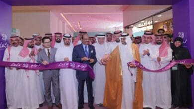 A group of people, including Yusuff ali in formal suits, are gathered for the grand inauguration of a new LuLu hypermarket.