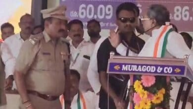 Karnataka CM Siddaramaiah raises his hand on ASP Narayan Baramani during a Congress event in Belgavi