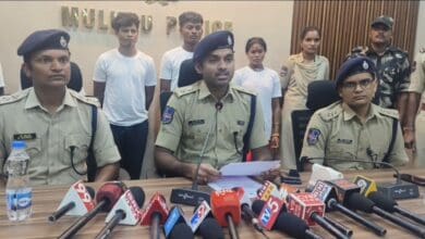 Image of Mulugu SP Shabarish at a press conference with surrendered Maoists.