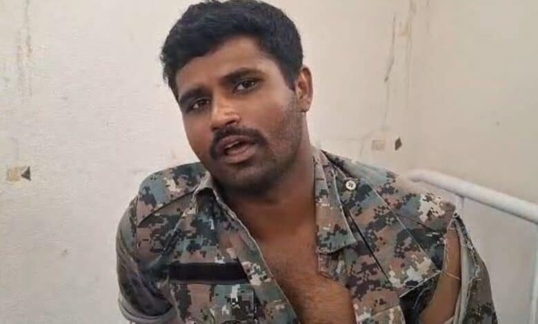 An injured police officer who was attacked by podu Multani farmers in Adilabad on Sunday
