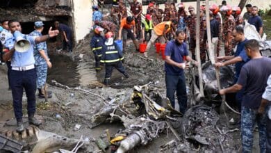 Firemen work at the site of a Bangladesh Air Force training aircraft that crashed into a college campus shortly after takeoff in Dhaka on Monday. (AP/PTI)