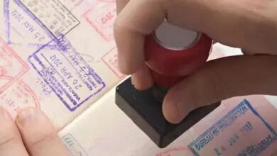 A person is stamping a stamp on a passport.