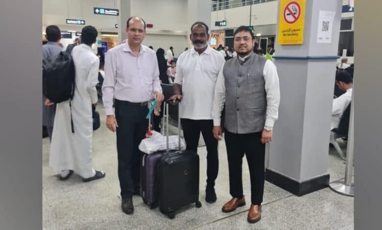 The image of a Augustin Dassayan (centre), the Indian survivor of a Red Sea ship attack, stands at a Saudi airport with Indian consulate staff before flying home.