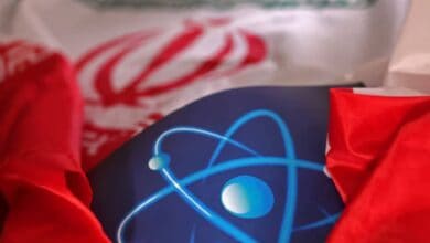 Illustration showing Iran's flag alongside an atomic symbol, representing the country’s nuclear programme.