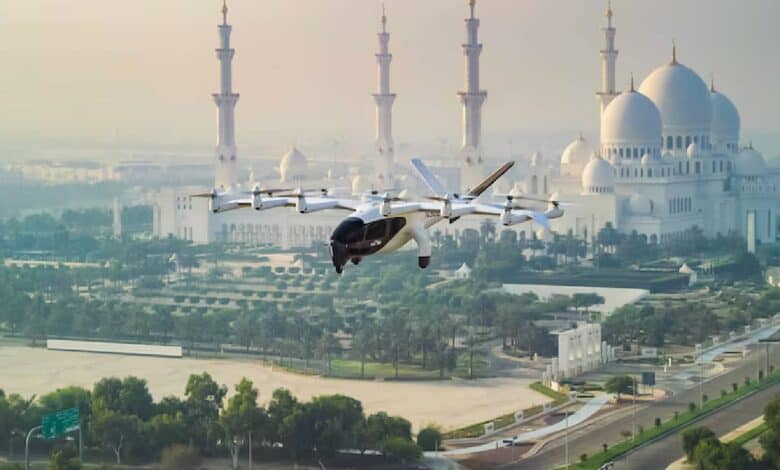 Archer’s Midnight electric air taxi flies over Abu Dhabi with Sheikh Zayed Grand Mosque in the background.