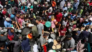 A crowded scene of Palestinians receiving food from a charity kitchen in Nuseirat, Gaza, amid a hunger crisis, July 20, 2025.