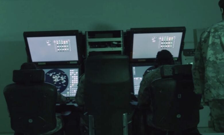 Qatari military personnel monitor radar and missile tracking systems inside an operations control room during Operation Breaking the Spears.