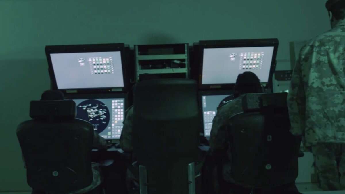 Qatari military personnel monitor radar and missile tracking systems inside an operations control room during Operation Breaking the Spears.