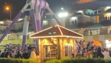 Crowds gather around a collapsed amusement park ride at night in Green Mountain Park, Taif, Saudi Arabia, following a mechanical failure.