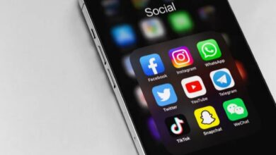 Smartphone screen displaying popular social media app icons including Facebook, Instagram, WhatsApp, Twitter, YouTube, Telegram, TikTok, Snapchat, and WeChat.