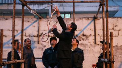 Iranian officials prepare gallows for a public execution.
