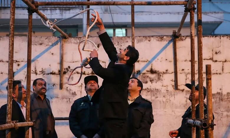 Iranian officials prepare gallows for a public execution.