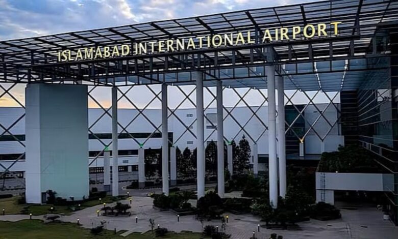 Front view of Islamabad International Airport with its modern glass-and-steel structure and illuminated signage at the entrance.