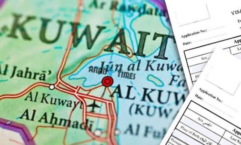 Map of Kuwait with visa application forms in the foreground.