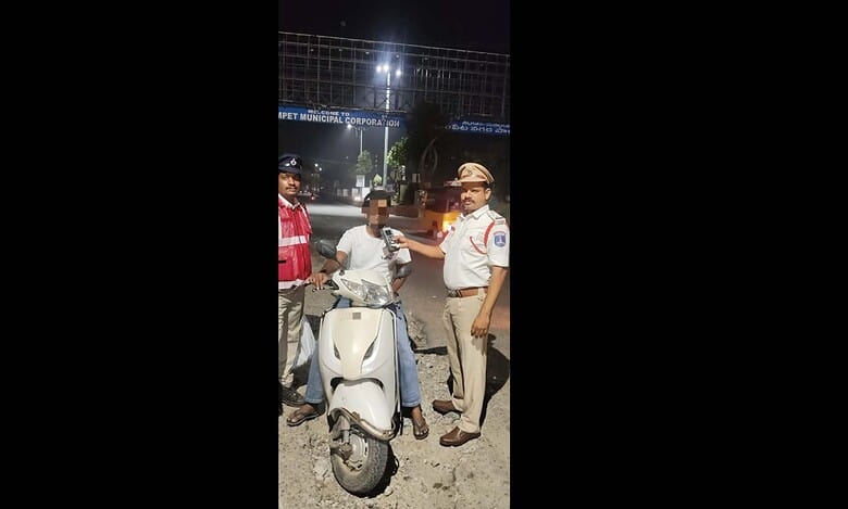 A man blows into a breathalyser in the Cyberabad commissionerate