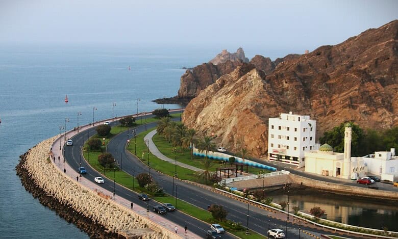 Curved coastal road by the sea in Muscat, Oman.