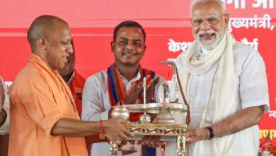 PM Modi being felicitated by UP CM Yogi Adityanath during a public meeting, in Varanasi.