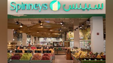Interior view of a Spinneys supermarket showcasing fresh fruits and groceries.