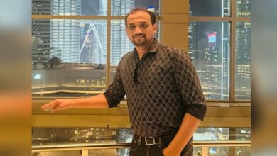 VP Shameer Medon, UAE-based Indian businessman, photographed indoors with a city skyline in the background.