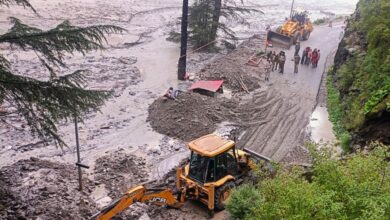 An excavator used to clear debris from a road following flash floods triggered by a cloudburst near Harsil in Uttarkashi district of Uttarakhand on Wednesday (PTI Photo)