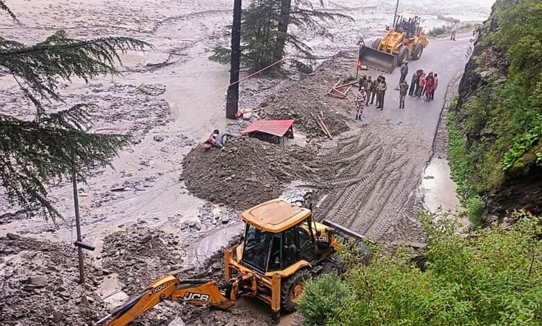 An excavator used to clear debris from a road following flash floods triggered by a cloudburst near Harsil in Uttarkashi district of Uttarakhand on Wednesday (PTI Photo)