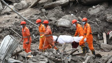 Rescue workers carry a dead body retrieved from the debri. Jammu and Kashmir's Chisoti village has been severly impacted by a cloudburst leaving 61 dead so far (PTI Photo)