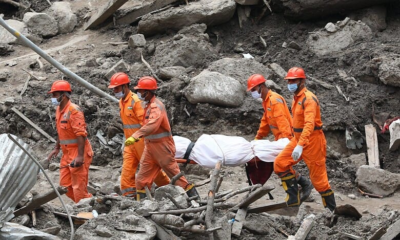 Rescue workers carry a dead body retrieved from the debri. Jammu and Kashmir's Chisoti village has been severly impacted by a cloudburst leaving 61 dead so far (PTI Photo)