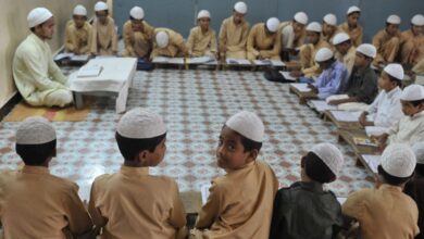 The image shows a madrasa with Muslim boys studying