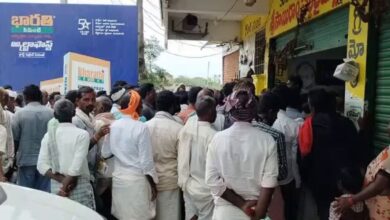 Farmers wait for their turn to receive urea in Pulkal village, Sangareddy